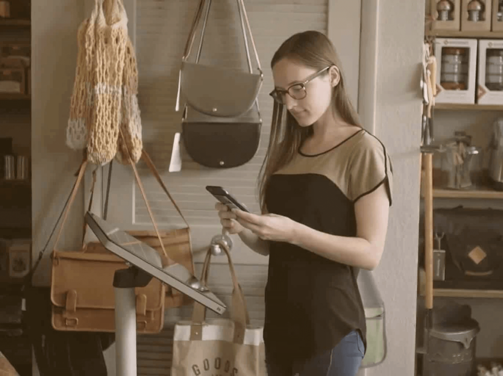 Person in a store using their phone.